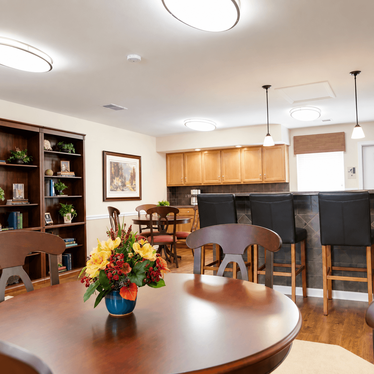 A dining room with a wooden table and chairs.